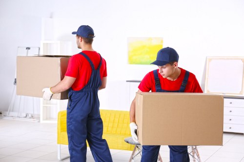 Moving team handling household items during a UK removal service