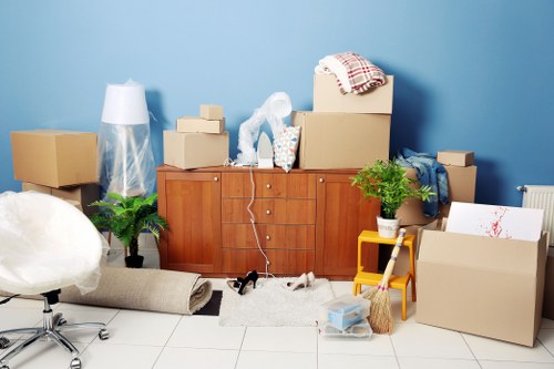 Moving team organising labelled boxes in a Wandsworth flat