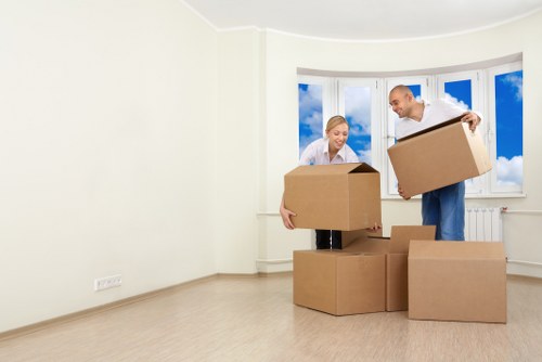 Removal team handling furniture and boxes in a local Wandsworth property