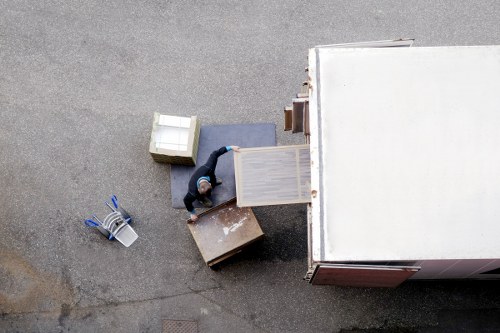 Professional movers carrying furniture from a Wandsworth home