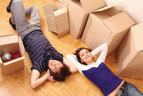 Local movers carrying furniture through a Wandsworth home