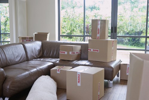 Moving boxes and furniture being loaded by a local removals team